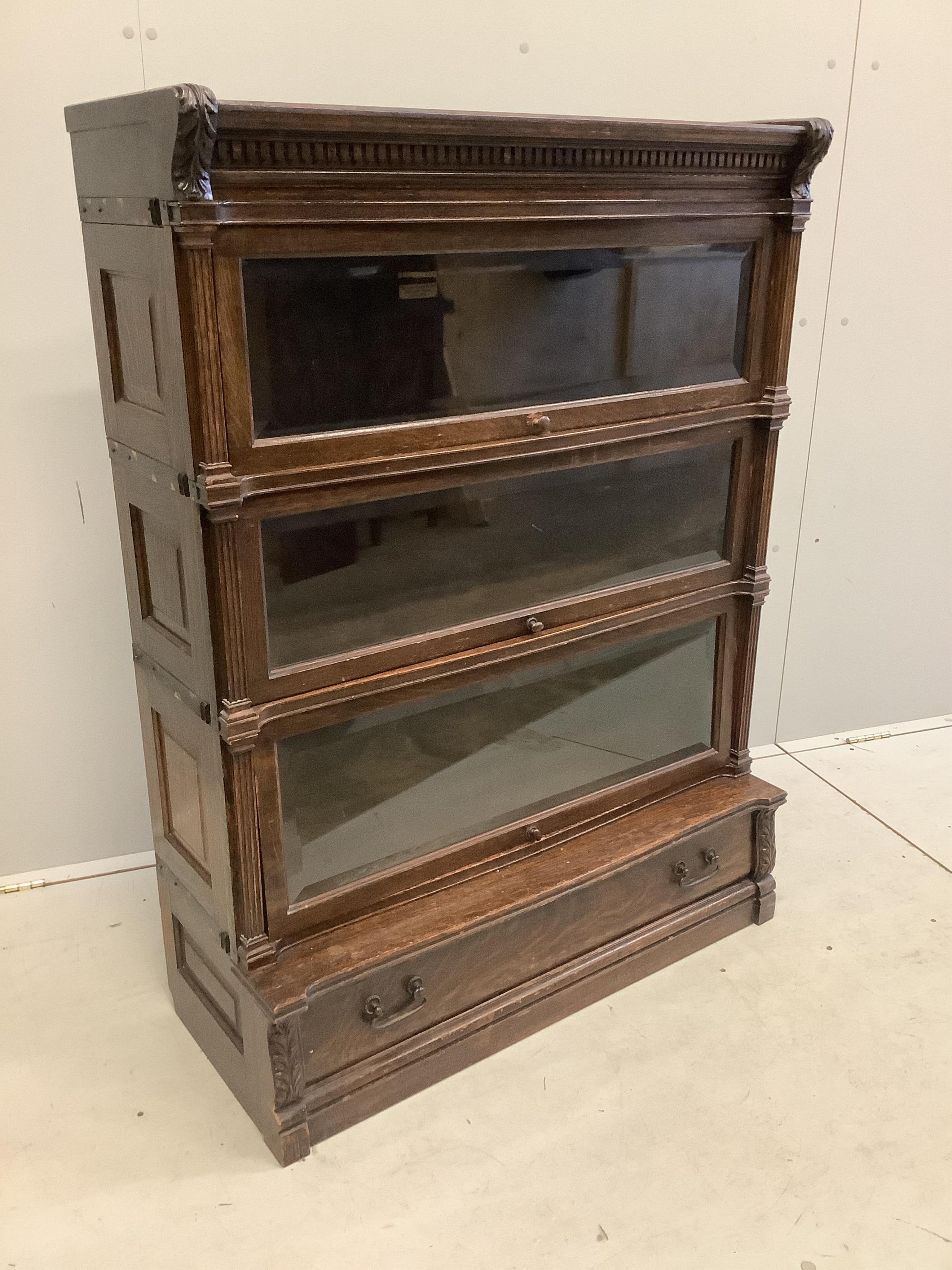 A Globe Wernicke oak three section bookcase, width 90cm, depth 38cm, height 121cm. Condition - fair